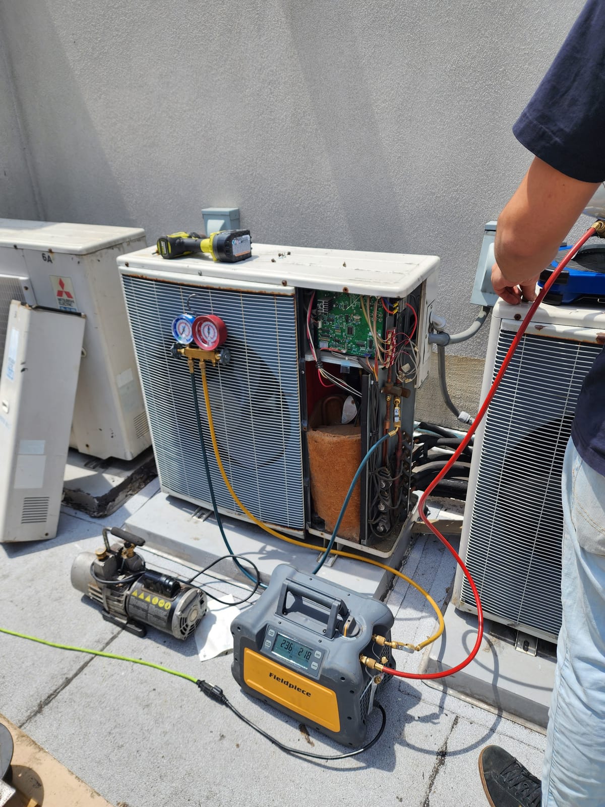 Technician servicing large LG multi-zone outdoor unit
